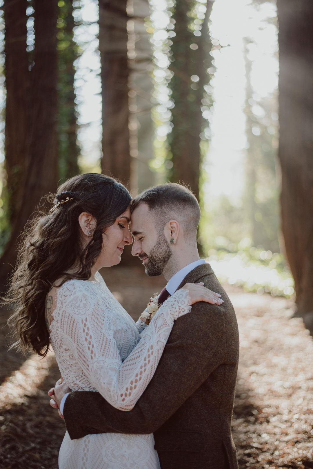 Bride and groom touch foreheads for wedding photo