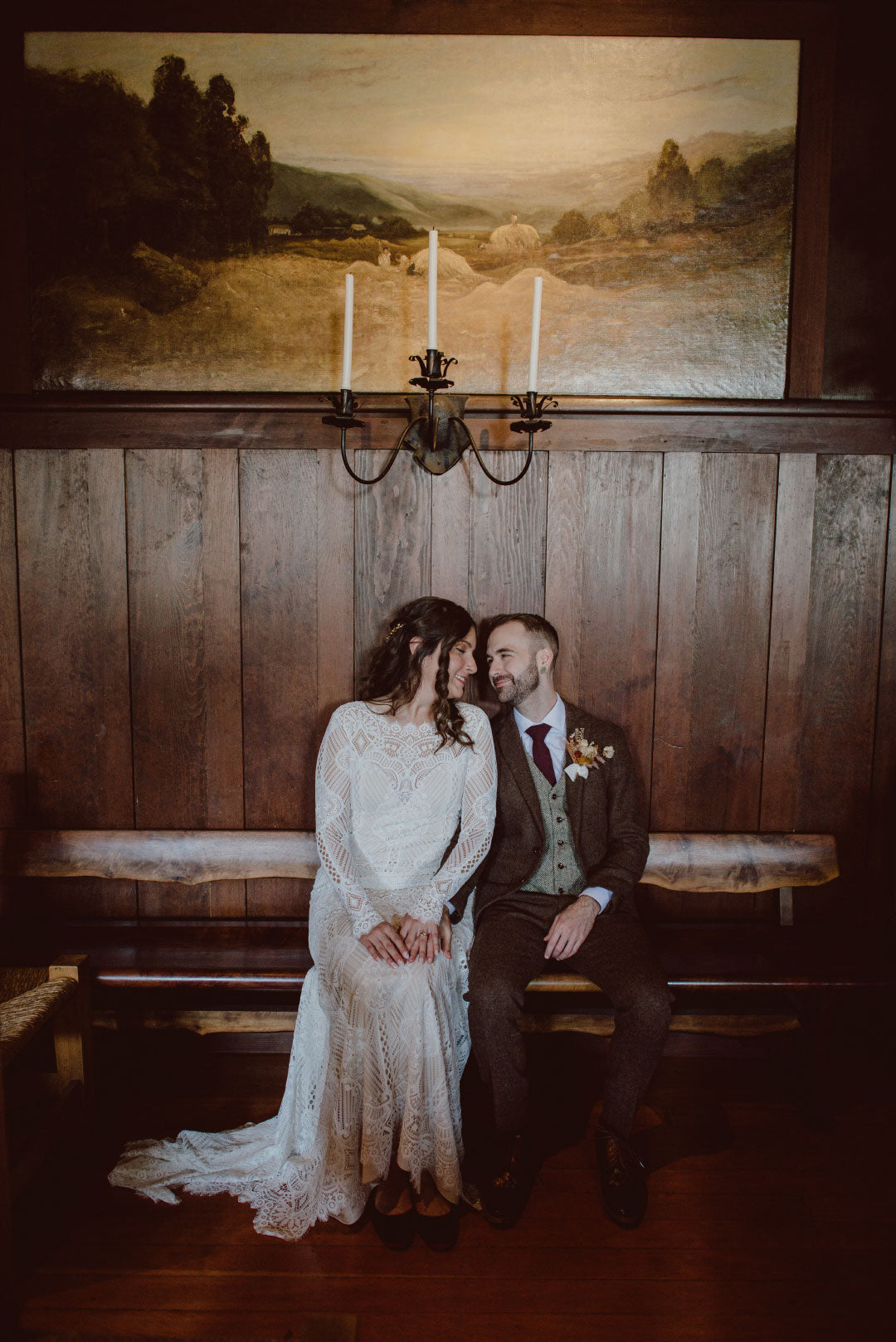 Bridea and groom seated wedding photo on bench