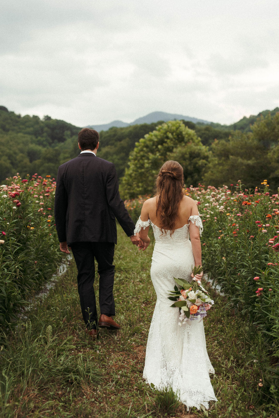 Bride and Groom in field after wedding ceremony