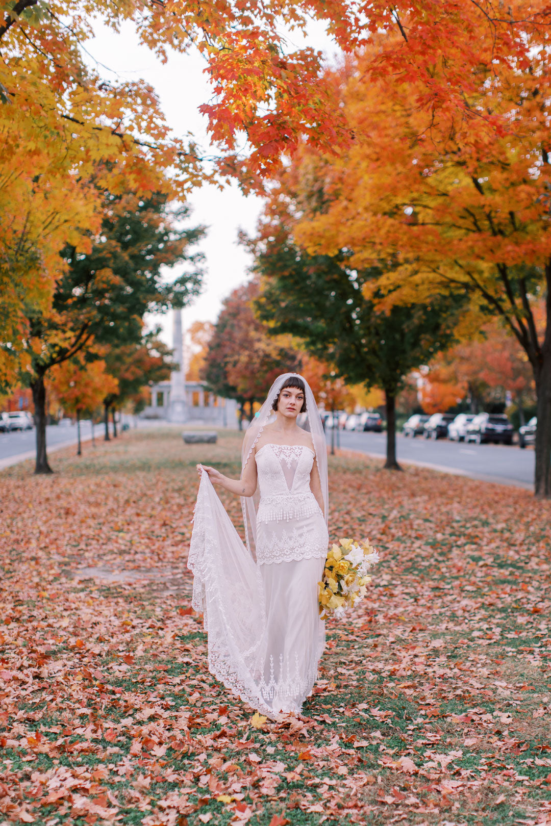 Victoriana Vintage Inspired Wedding Dress Bride walking with fall color leaves