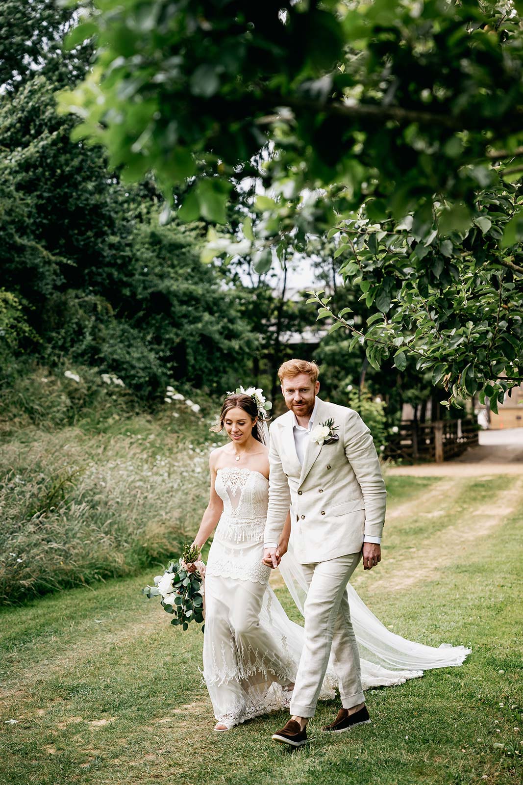 Bride and Groom walking Bride in Victoriana by Claire Pettibone