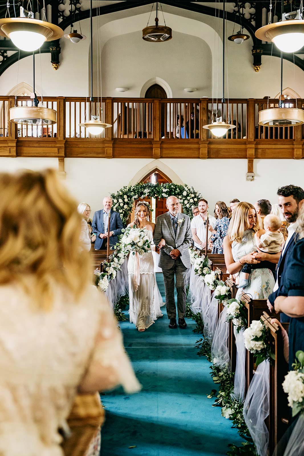 Bride entering chapel for wedding ceremony