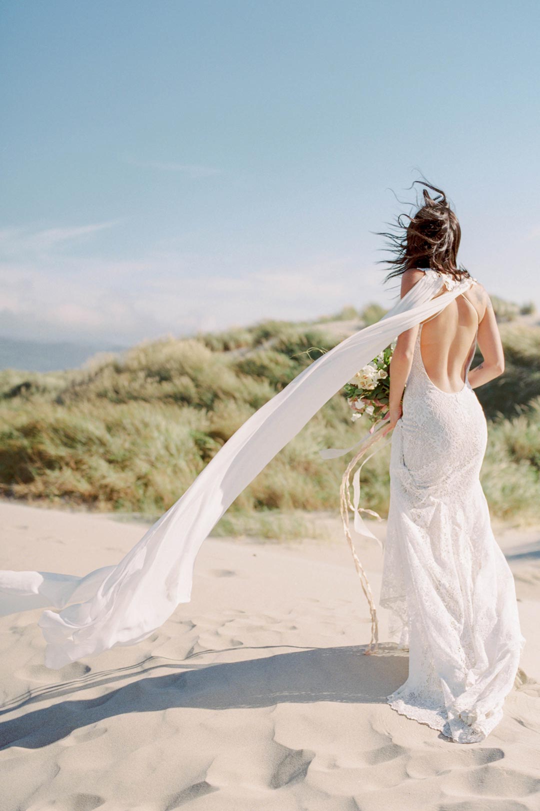 Bride at Beach Sand Dune in Saratoga Plunge Back Wedding Dress