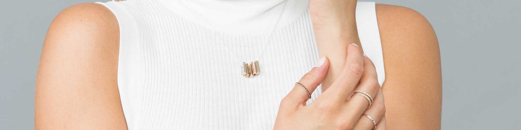A white shirt as a blank canvas - Show off mixed metal shorty pendant necklace and ring stacks.