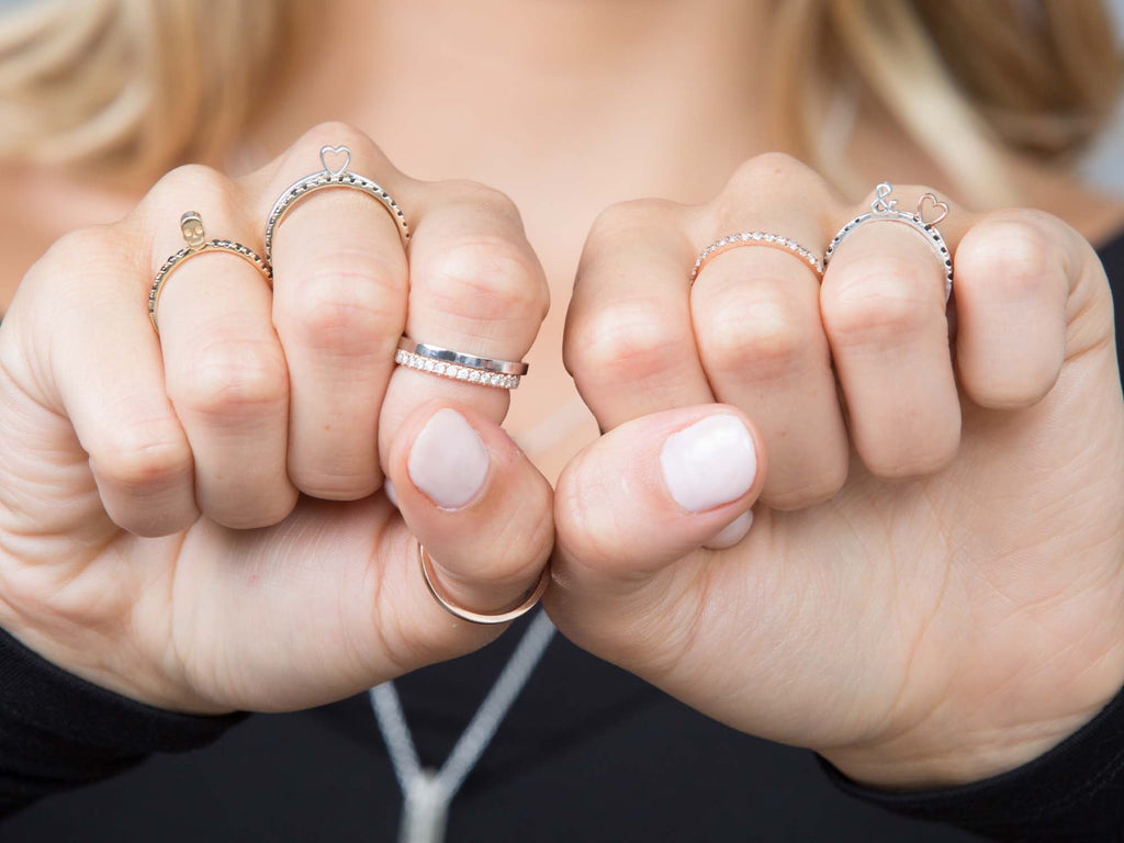 a mixed stack of diamond and gold rings