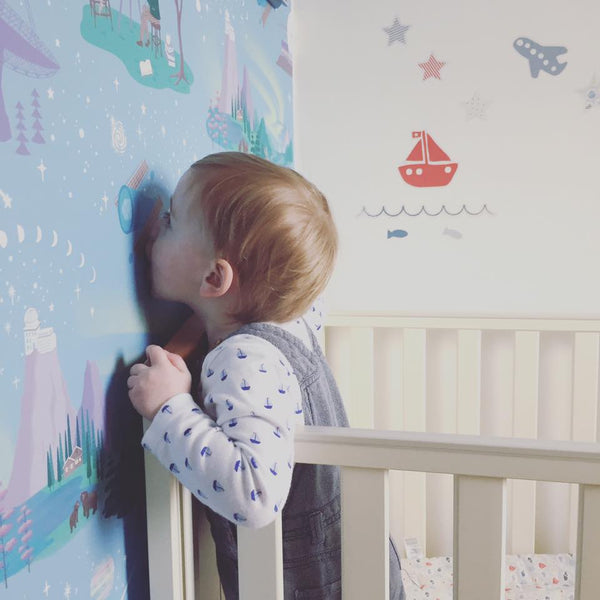 Little boy kissing his Renn Designs Northern Lights wallpaper