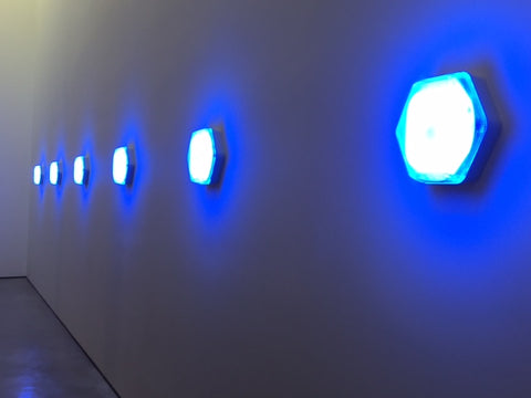 Blue lights with neon glow on blue wall at Hepworth Gallery