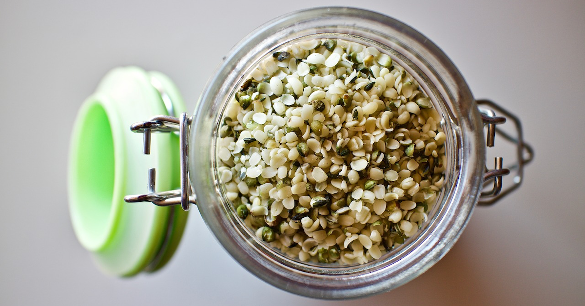 An opened jar of hemp seeds 