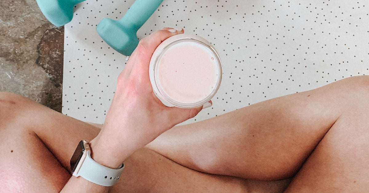 A person holds a protein smoothie