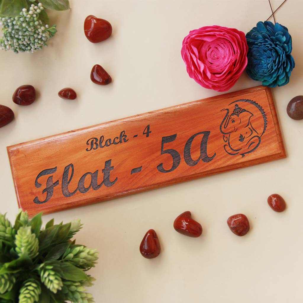 Ganesh Name Plate As Return Gifts For Ganesh Chaturthi. This Personalized Name Plate With Flat Number Is The Best Ganesh Chaturthi Gifts. Looking for Gifts Online? This Wooden Name Plate Makes A Perfect Festival Gift. This Wooden Door Nameplate Makes An Auspicious Gift For Family.