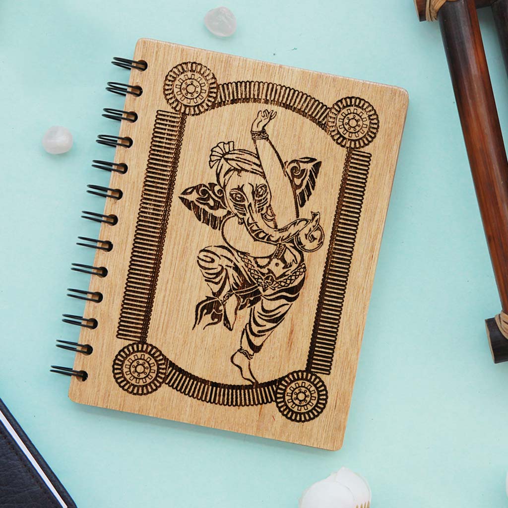 A Spiral Notebook Engraved With A Picture Of Lord Ganesha. This Personalized Journal Notebook is one of the best Ganesh Chaturthi gifts. It also makes great  Return Gifts For Ganesh Chaturthi.