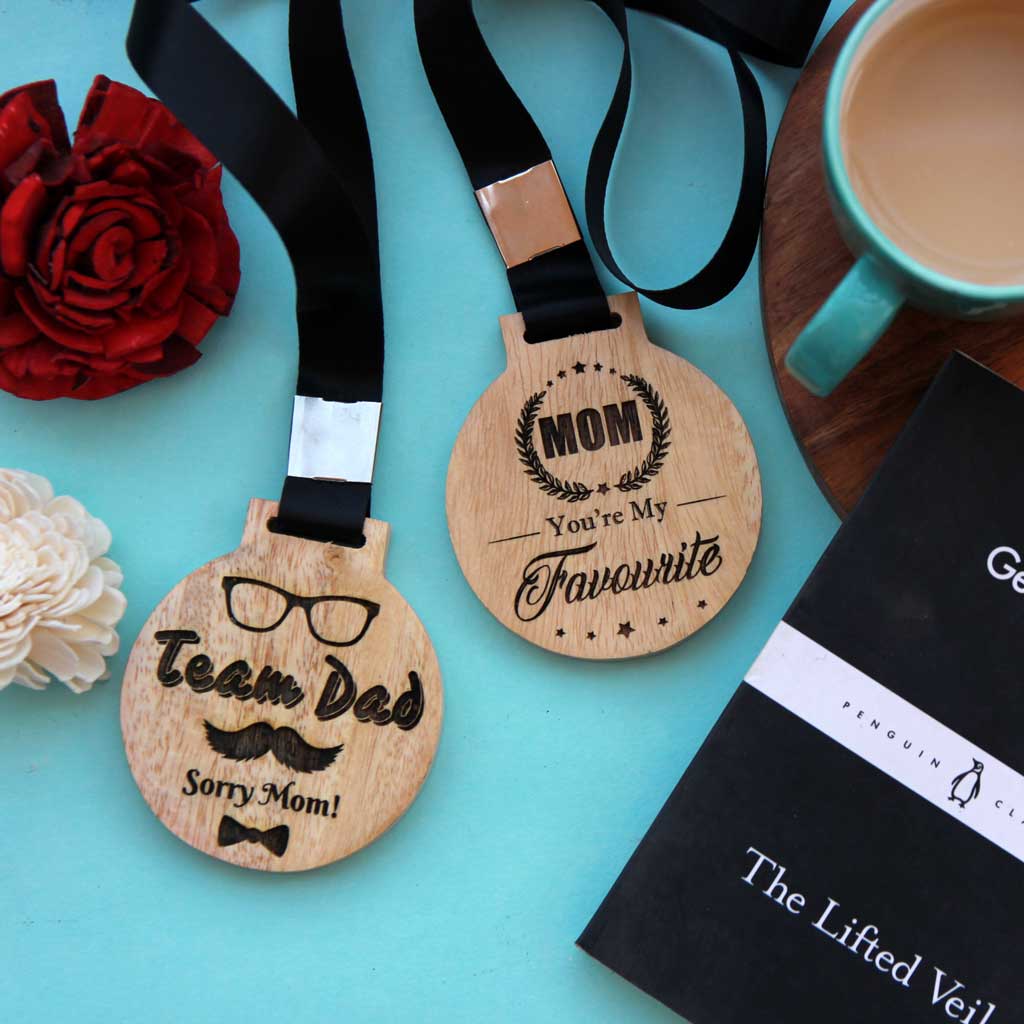 Team Dad, Sorry Mom Wooden Medal. Mom You're My Favourite Wooden Medal. These Wooden Medals Make Cute Gifts For Parents. These Engraved Medals Makes Perfect Father's Day Gift Or A Mother's Day Gift