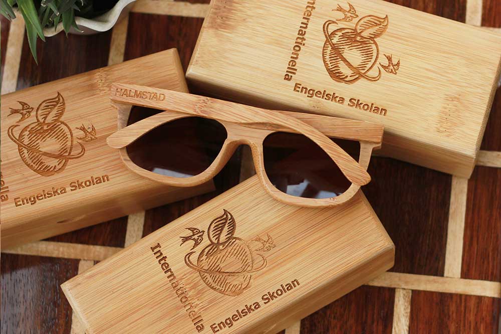 Wooden Sunglasses As Corporate Gifts for Internationella Engelska Skolan, Halmstad, Sweden. Custom Sunglasses engraved with company name as promotional gifts. These bamboo sunglasses come with a bamboo sunglasses case engraved with client's name and your company logo. Sunglasses make unique corporate gift ideas.