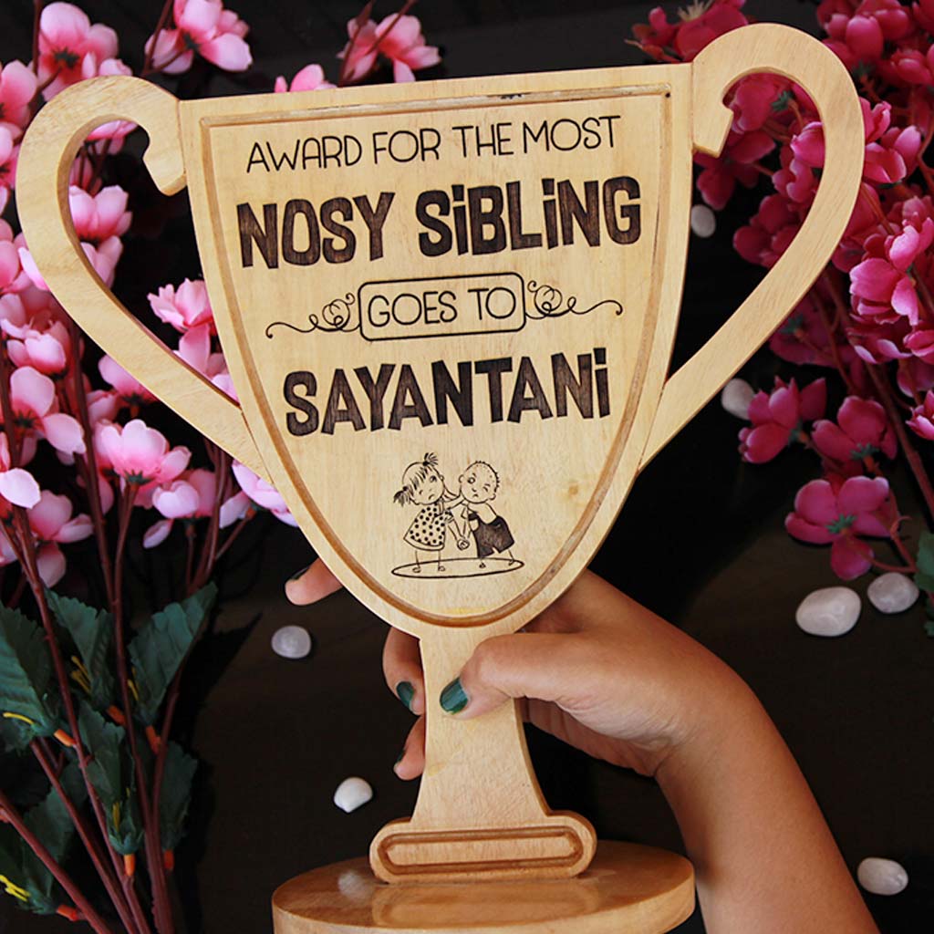 Personalized Wooden Trophy Cup For The Most Nosy Sibling. This Wooden Award Makes A Unique Rakhi Gift For Siblings. Buy More Raksha Bandhan Gifts From The Woodgeek Store.