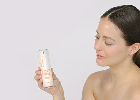 Woman with fair skin holding an Urban Skin Rx® product