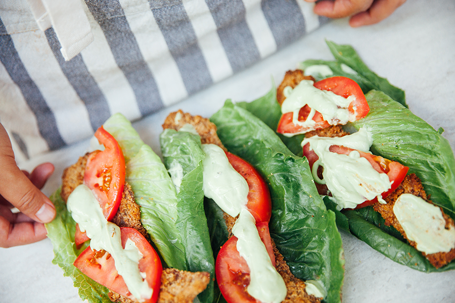 Three jalapeno crackling coated blt wraps laying on a table. 
