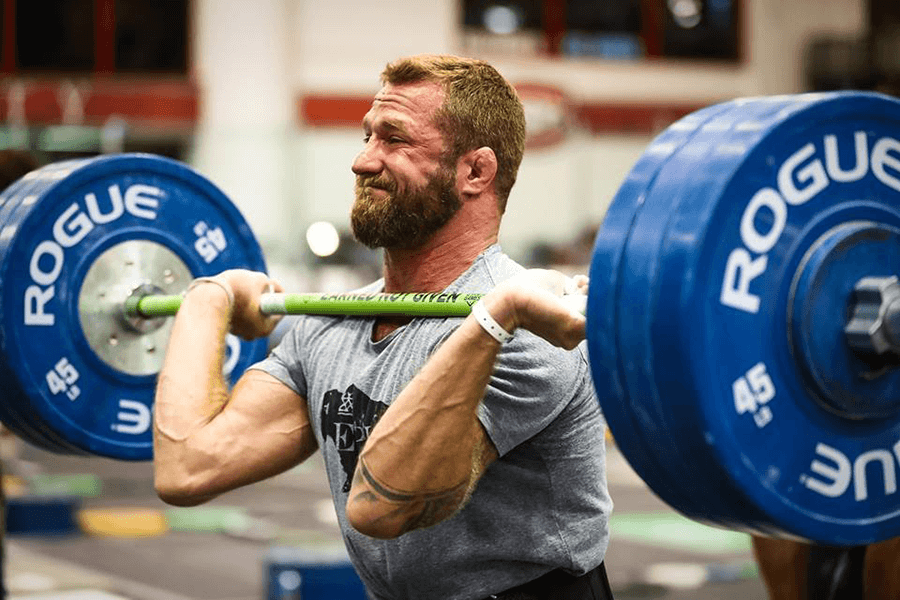 Man wearing an EPIC Provisions shirt lifting weights in a CrossFit Competition