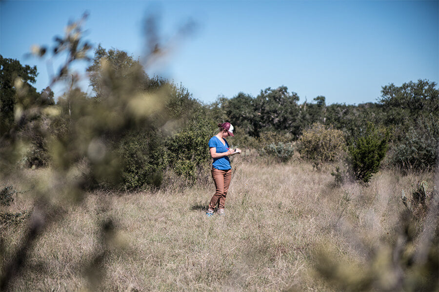 Woman standing in barren field