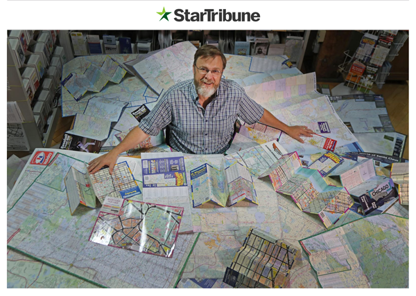 Tom Hedberg surrounded by many of the maps he has made through the 26+ years in the map industry
