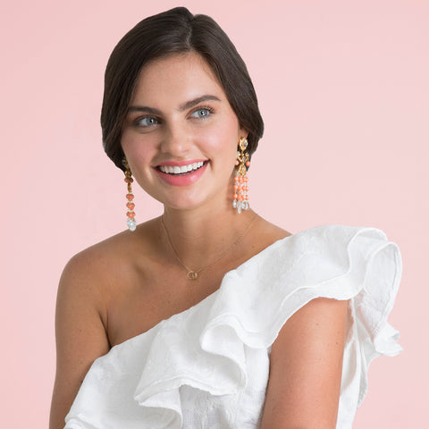 Bride wearing one shoulder white cocktail dress with Bounkit earrings