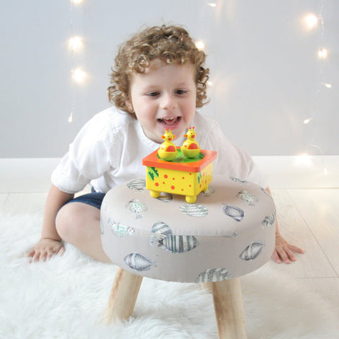 Henry playing with the Giraffe music box