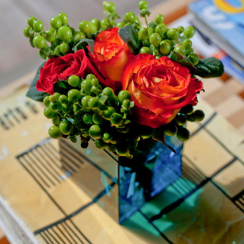Red roses in a slate 105C box, on magazines