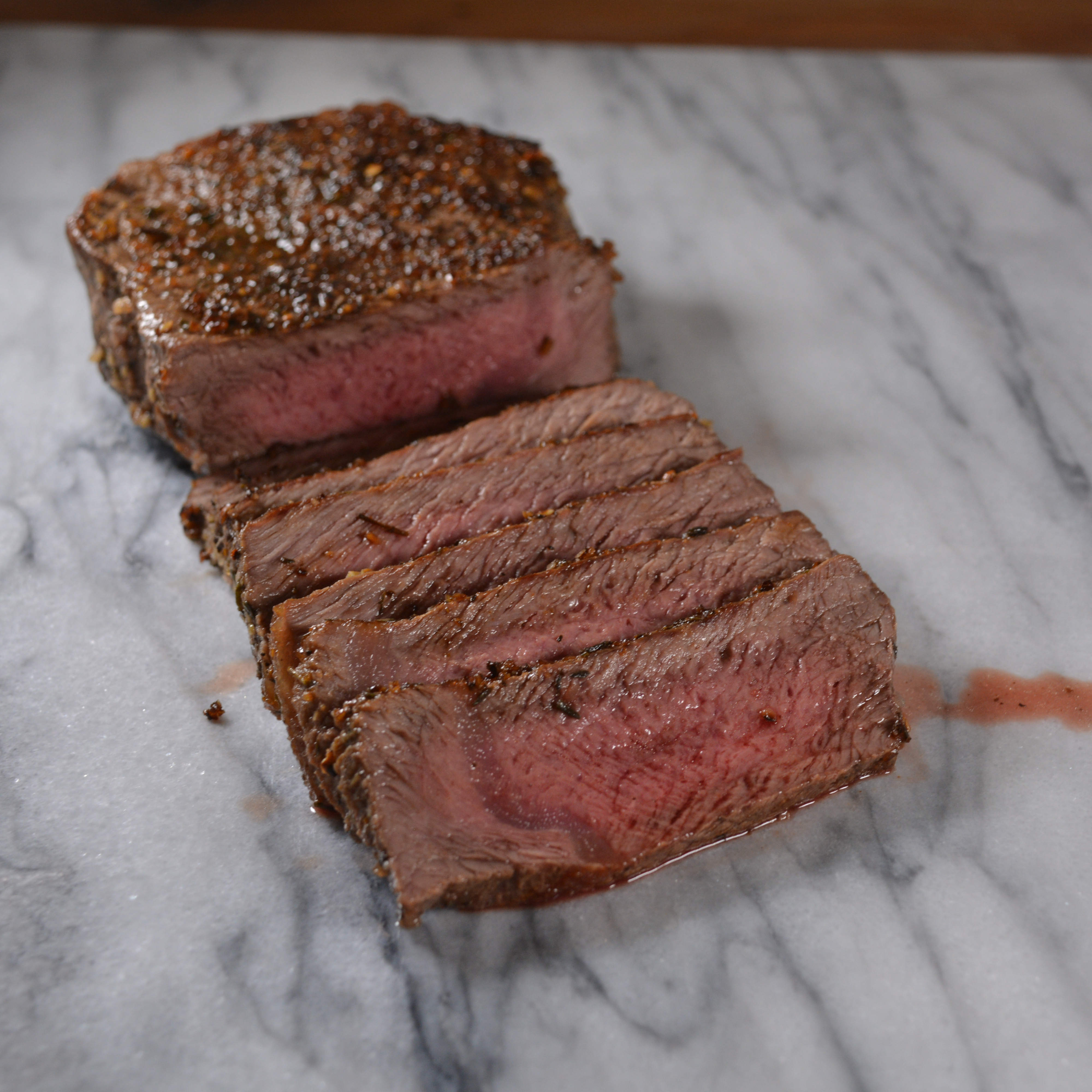 Grass-fed beef shoulder steak cooked to medium rare on a cinder precision grill 