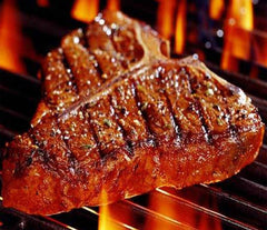 Steak searing over a charcoal chimney