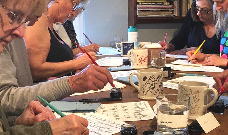 A Beginner Copperplate Calligraphy Workshop in full concentration practicing their strokes.