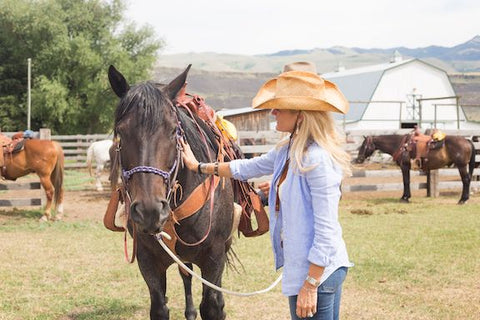 arthur m blank foundation, AMB basecamp, montana living, woman with horse at montana ranch