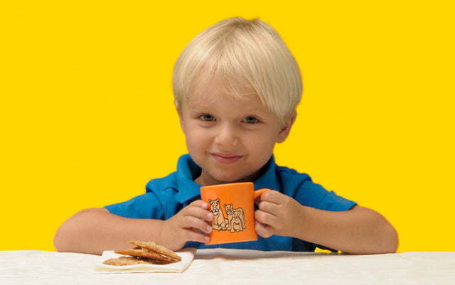 Toddler holding orange lion BittyMug