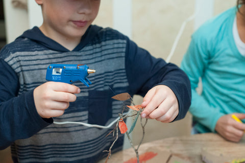 Older kids can use the glue gun, while adults can help smaller kids get the leaves on right