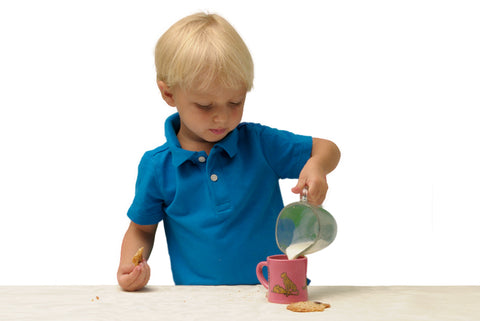 Toddler pouring his own milk into a BittyMug