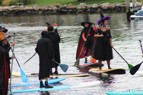 a gathering of paddling witches on the Mystic River