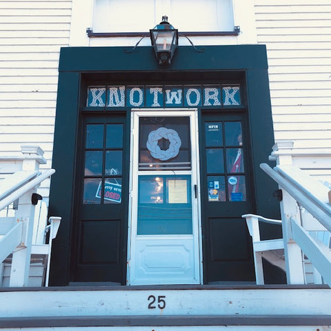 Knotted letters sign above door at Mystic Knotwork