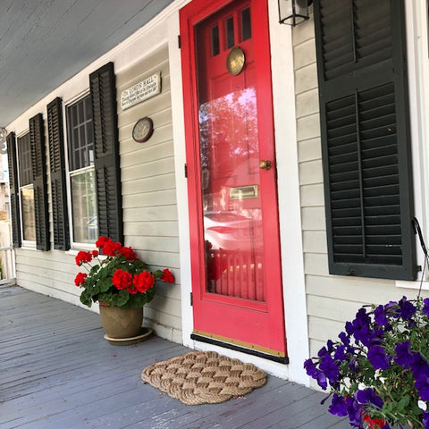 cool red door with a manila door mat