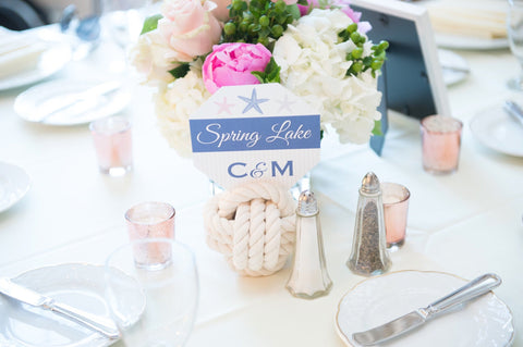 wedding table with pink flowers and knot number holder