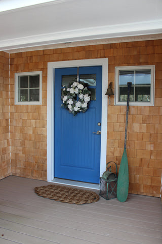 Our large door mat in front of a bright blue door