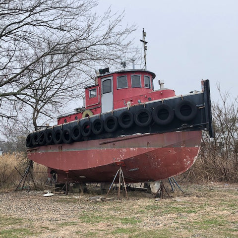 red tug boat on the hard in Mystic