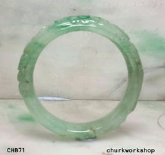 Small carved light green jade bangle