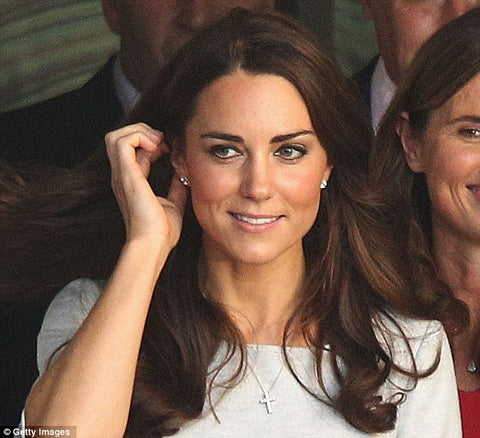 Catherine Duchess of Cambridge Kate Middleton wears cross pendant necklace
