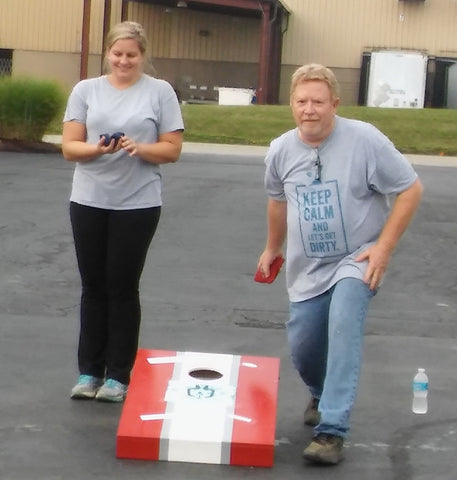 Ag Lab Manager Marty Snodgrass and Veronica Kwasny compete in a friendly game of cornhole