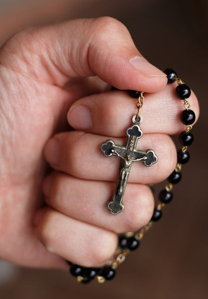 hand holding a rosary