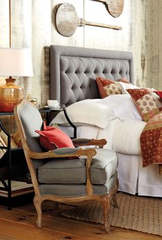 lofty french armchair next to modern bed. 