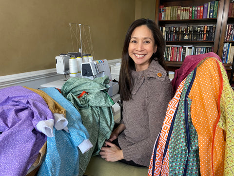 Jennifer Cura, founder of The Patchwork Bear making isolation gowns
