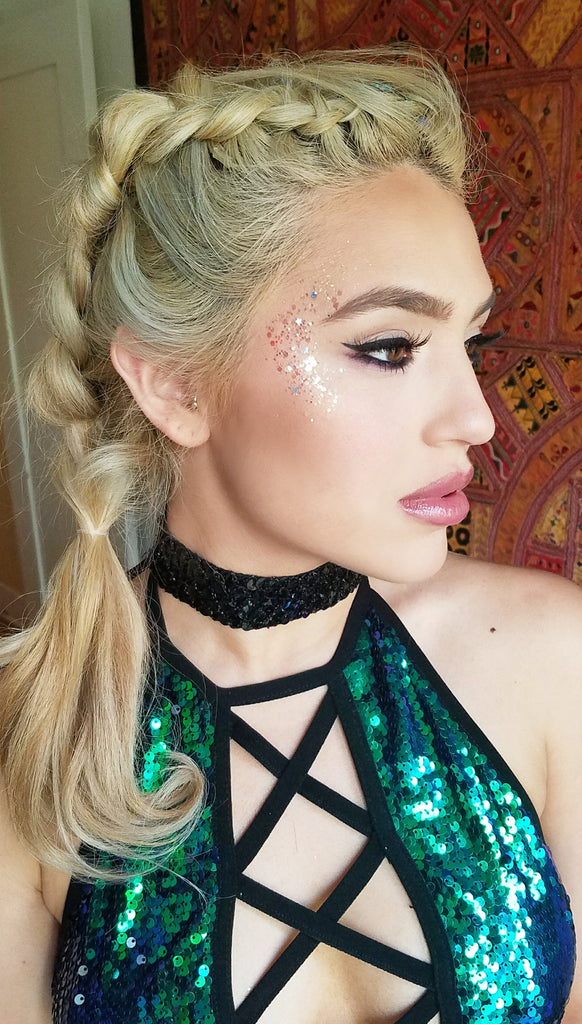 Glitter highlight on rave girl wearing sequin criss cross halter top
