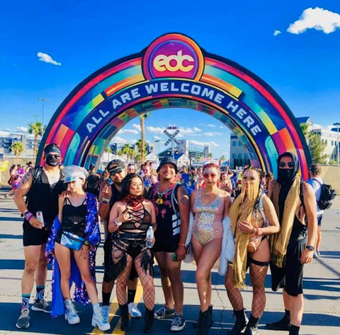 Rave squad posing in front of all our welcome sign at EDCLV