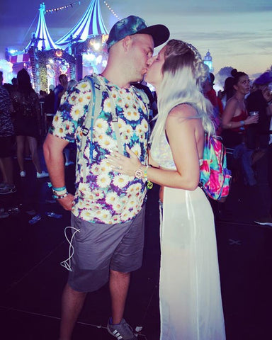 rave couple share a kiss at a festival