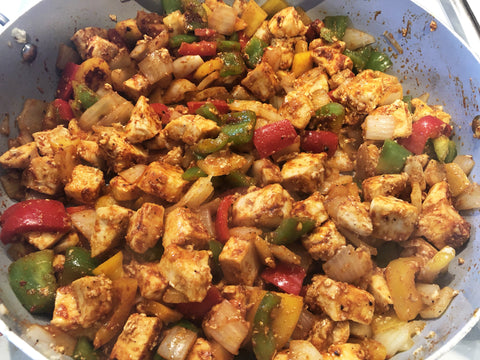 photo of chicken breast, peppers, and onion tossed in chili seasoning