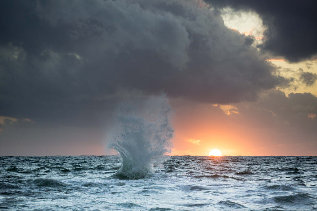 Wave crashing at sunset